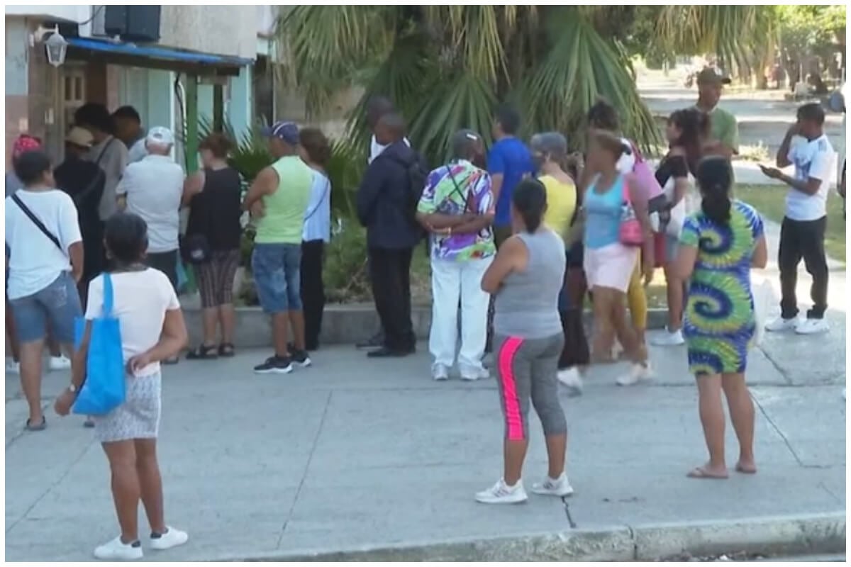 Larga fila en un cajero automático, la falta de efectivo hace que la gente se junte cuando llega a haber dinero. (Captura de pantalla © DW en Español- Facebook)